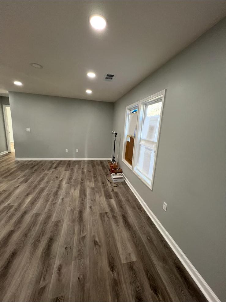 Finished room with new gray vinyl plank floor
